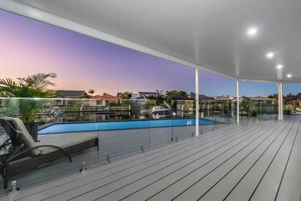 Seamless indoor-outdoor home extension in Melbourne featuring a luxury swimming pool and glass fencing by Destin Constructions.