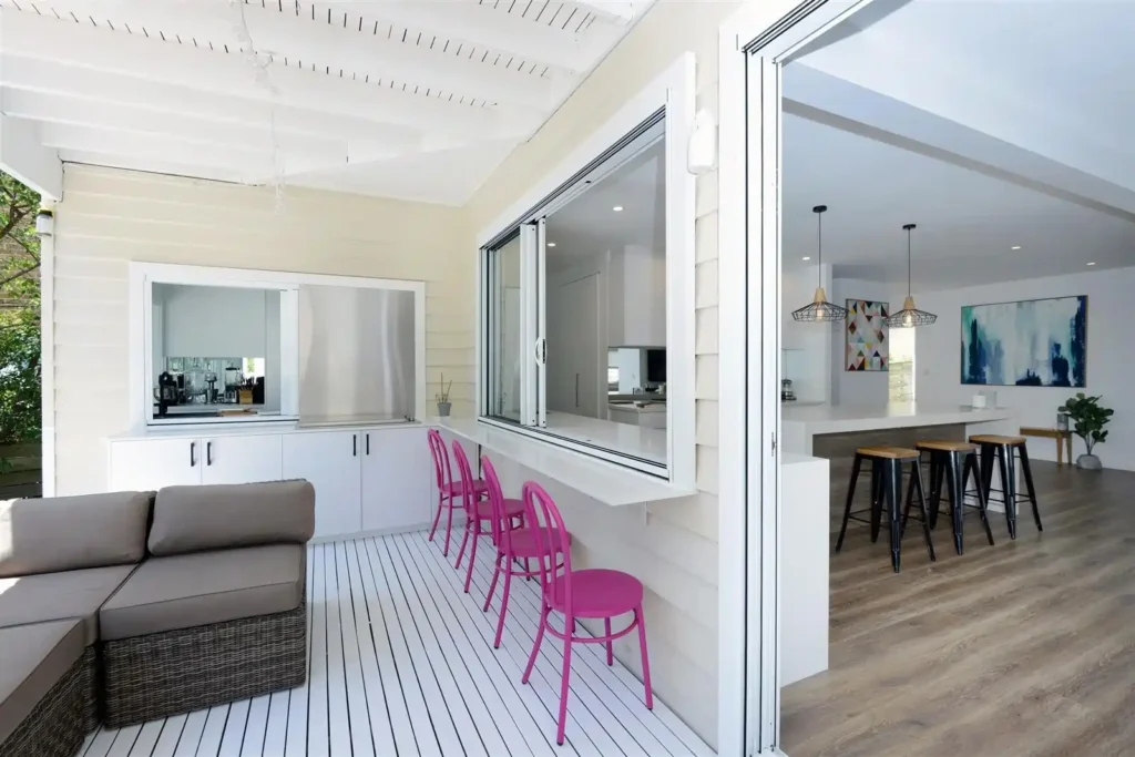A completed contemporary kitchen renovation in a Melbourne home by Destin Constructions, featuring an island bench, stone countertops, and pendant lighting.