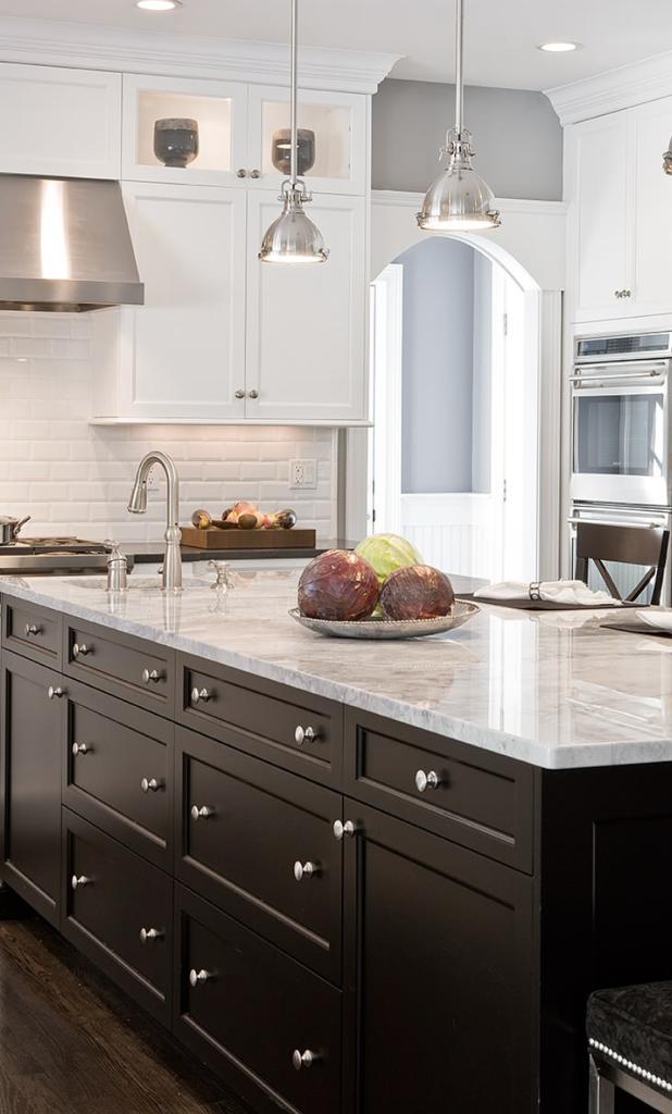 Modern open-plan kitchen renovation in Melbourne featuring custom white cabinetry and stone island bench by Destin Constructions.